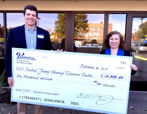 Andy Nowack (Left), Executive Vice President of Premier Development, presents a $10,000 donation to Sharon Clark (Right), Executive Director of CJHRC, a 501 (c) non-profit organization which provide counseling, information and referral services to low-and moderate-income people seeking housing.